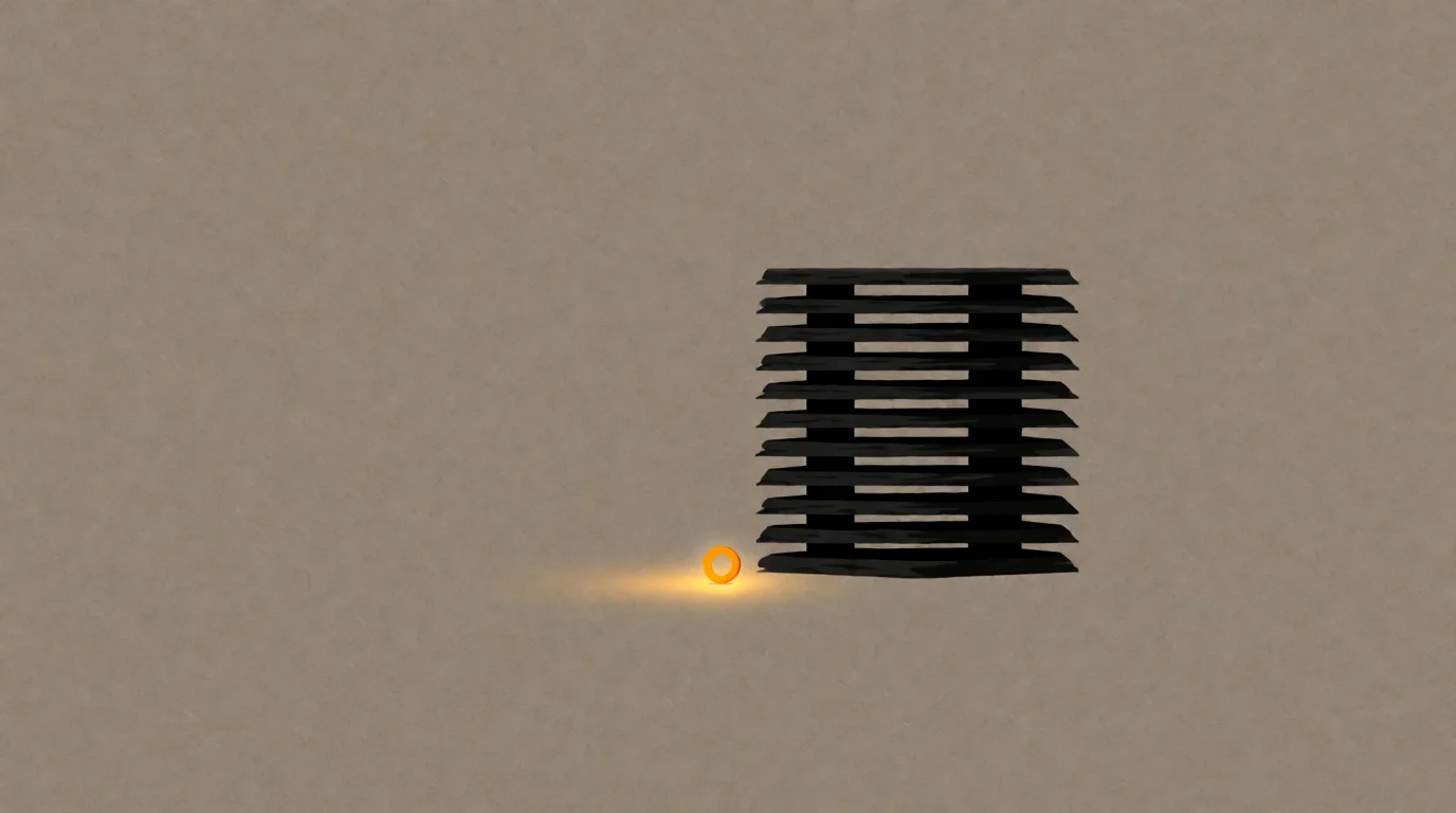 A tall hollow tower of nine dark slabs, and at its base one tiny glowing amber ring