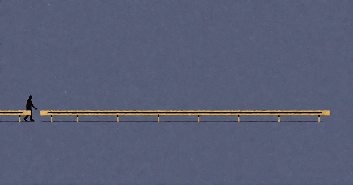 Golden guardrails extending far beyond a small dark figure who has let go, continuing on their own
